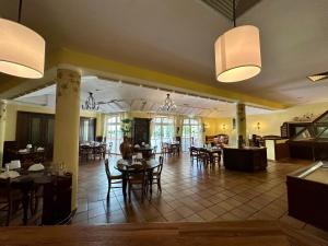 a dining room with tables and chairs in a restaurant at Hotel Landhaus Milser in Duisburg