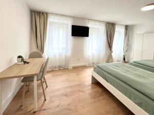 a bedroom with a desk and a bed and a table at Privatzimmer in Apartment Brunnenstraße Braubach in Braubach