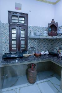 a kitchen with a counter top with pots and pans at Meri Chhat Homestay in Jāmb