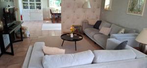 a living room with a couch and a table at Guesthouse 10 in Schellinkhout