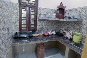 a kitchen with a counter with a sink and a stove at Meri Chhat Homestay in Jāmb +20 photos