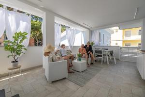 a group of people sitting in a living room at Romantic beach house with jacuzzi in San Mauro a Mare