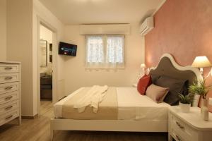 a bedroom with a large bed and a window at Romantic beach house with jacuzzi in San Mauro a Mare