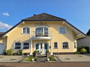 a yellow building with a sign on it at Haus Marvin in Döttingen