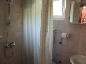 a bathroom with a shower curtain and a sink at CROSurf Apartments Pelješac Kučište in Kučište +44 photos