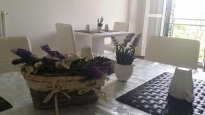 a dining room with a table with a basket of flowers at Carpe Diem Ancona in Ancona