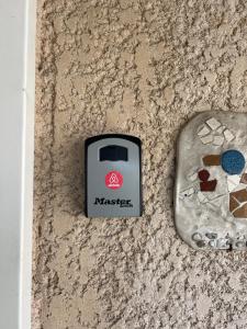a electronic device on a wall next to a rock at Roissy CDG, private room 4 in Roissy-en-France