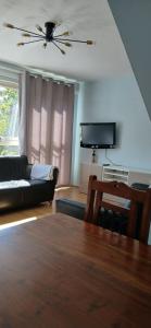 a living room with a couch and a tv at Mary's Place in Plumstead