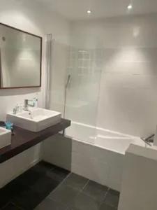 a white bathroom with a sink and a shower at Maison confortable à La Garde-Freinet, 160 m², vue ville in La Garde-Freinet
