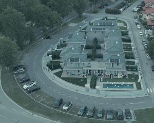 a large house with cars parked in a parking lot at Polinesia 5 in Lido delle Nazioni