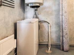 a kitchen with a refrigerator in a room at 4 person holiday home in Slöinge in Ugglarp +4 photos