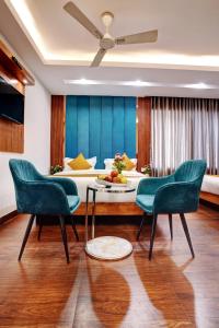 a living room with a bed and a table and chairs at Hotel Cabana 5 Mins Walking Distance From NDLS Station in New Delhi