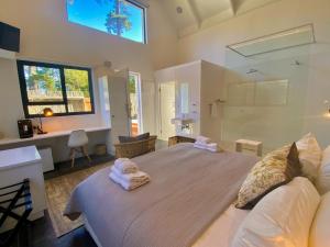 a bedroom with a large bed with towels on it at Vida Nova Retreat in Hout Bay