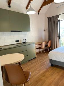 a room with a bed and a table and chairs at Tsiskari Cottages in Sadmeli