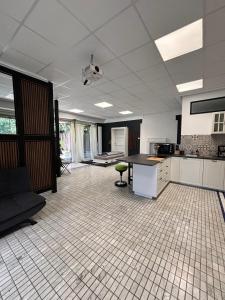 an empty room with a kitchen with a counter top at Villa Arche 1 in Neuenkirchen-Vörden +17 photos