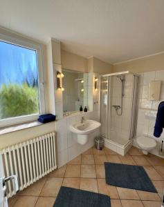 a bathroom with a shower sink and a toilet at Haases Ferienwohnung in Remscheid +11 photos