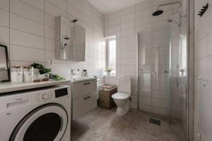 a white bathroom with a toilet and a shower at Lägenhet mitt i Kungshamn in Kungshamn