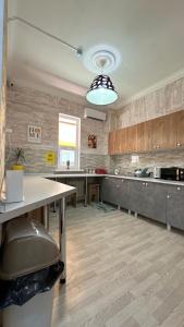 a large kitchen with a table and a counter at Premium Hostel Atyrau in Atyrau +37 photos