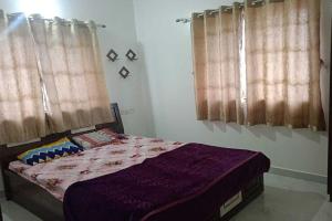 Postel nebo postele na pokoji v ubytování Vighnaharta Villa