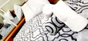 a bed with white sheets and towels on it at LG318 New Brenthill Premium Condo near SMBaguio in Baguio