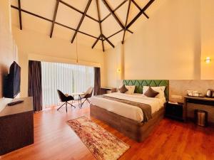 a bedroom with a large bed and a table and chairs at Bestinn Leisure Myst Private Villa Ooty in Ooty