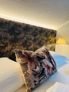 a pillow sitting on top of a bed at DAHUAM SUITES GERLOS Ski in Appartements mit BalkonITerrasse in Gerlos