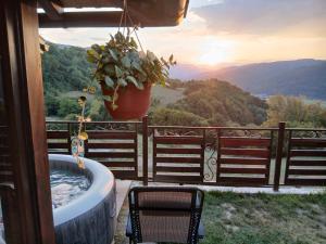 a bath tub on a balcony with a view of the mountains at Apartman Sofiana in Bajina Bašta