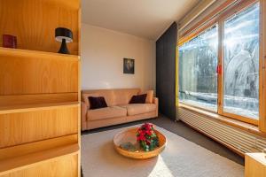 a living room with a couch and a table at G3 appartamento 21 Pila- Gressan in Pila