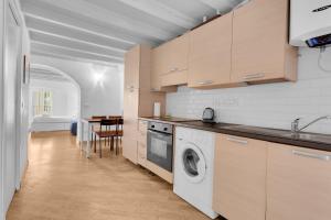 a kitchen with a washer and dryer in it at The house of Ripa di porta ticinese 13 in Milan