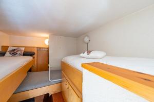 a small room with two beds in a room at G3 appartamento 21 Pila- Gressan in Pila