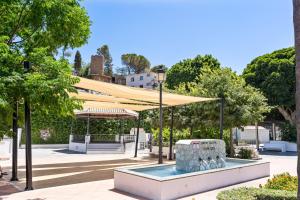 a large tent in a park with a fountain at Casa Rija - Renovated 2BR - Heart of Mijas Pueblo in Mijas