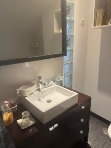 a bathroom with a sink and a mirror at Beautiful duplex with sea view in Vila Praia de Âncora +24 photos