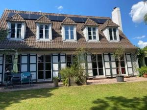 a house with windows and a roof at Grande maison à Santes avec jardin in Santes