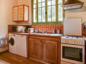 a kitchen with a sink and a stove top oven at Elegant Normandy Escape in Portbail