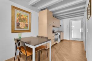a kitchen with a table and chairs in a room at The house of Ripa di porta ticinese 13 in Milan +9 photos