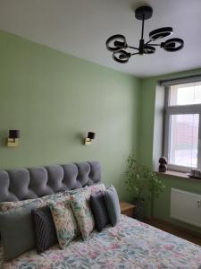 a bedroom with a bed with pillows on it at Siauliai Apartments - Traku in Šiauliai