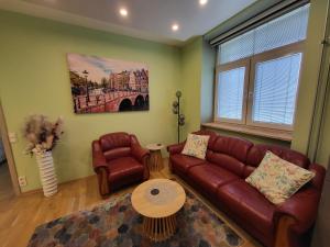 a living room with a couch and a table at Siauliai Apartments - Traku in Šiauliai