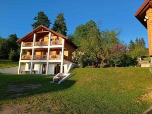 a large house on a hill with a grass field at Nonićeva Hiža in Fužine