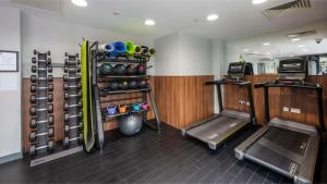 a fitness room with a gym with weights and equipment at Students Only Straits Egham - 40 mins to Waterloo - Direct Bus to Heathrow in Egham