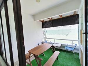 a table and chairs in a room with a window at PD Lagoon Paradise South H-G-1 in Port Dickson