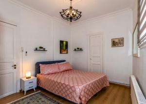a bedroom with a bed and a chandelier at The Heaven on Heritage Street in Istanbul
