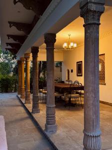 a group of columns in a room with a table at CABANA- 5 BHK Luxury Villa near Udaipur in Dabok