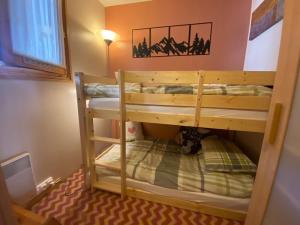 a bunk bed room with two bunk beds at Jardin des Neiges - 11A in Samoëns