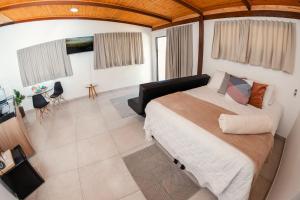 a bedroom with a large bed in a room at Chalés Alta Vista in Bananeiras