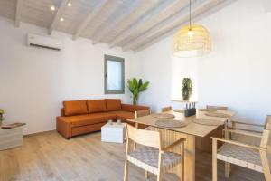 a living room with a table and a couch at Roots Villa in Skinés +33 photos