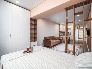 a bedroom with a bed and a living room at Апартамент на Тулебаева! in Zhezdi