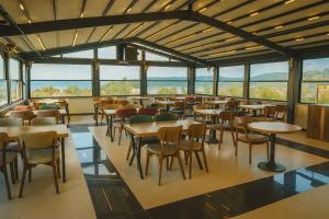 a restaurant with tables and chairs and windows at Rest By Dedeman Sapanca in Sapanca