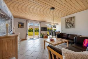 a living room with a couch and a table at Holiday house Løgten Tversted in Bindslev