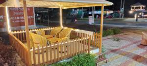 a gazebo with chairs on a porch at night at Shyam Krapa in Rīngas +23 photos