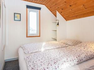 a bedroom with a bed and a window at 4 person holiday home in Lemvig in Lemvig +29 photos